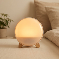 Round sunrise wake-up light glowing warm amber
