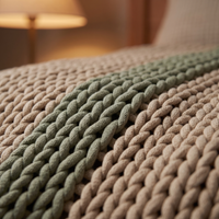 Close-up of the chunky oat and sage open knit of the weighted blanket