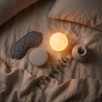 Overhead flat-lay of the Deep Sleep Kit: sleep mask, sound machine, sunrise light and diffuser