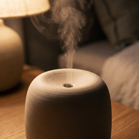 Close-up of the ceramic diffuser's matte surface with mist rising from the vent