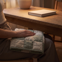Weighted lap pad resting across the lap at an oak desk
