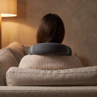Woman wearing the cordless neck massager resting on her shoulders